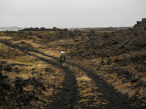 Anonymous pilot walking on desolated planet