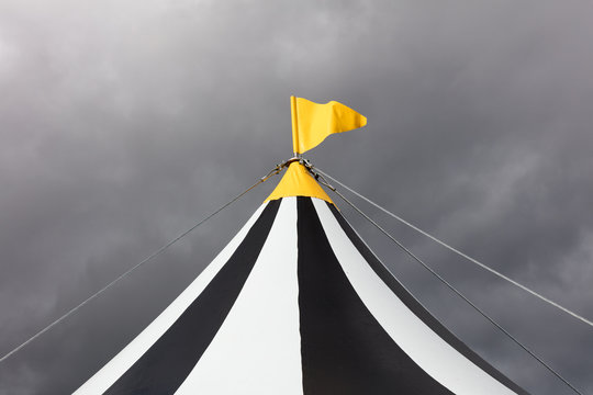 A yellow flag on a circus big top