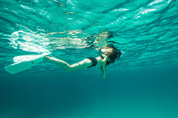 A young beautiful woman is enjoying a snorkeling session