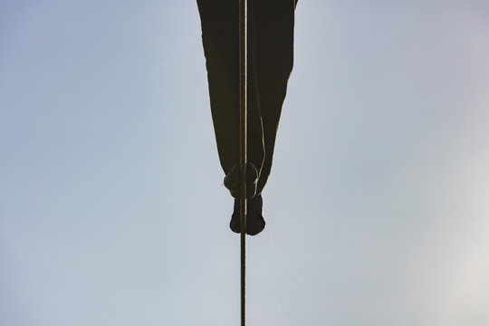 A lose up of the feet of a tightrope walker on a wire.
