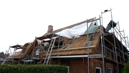 A new thatched roof for an old residential building.  Germany Schleswig Holstein. © anela47