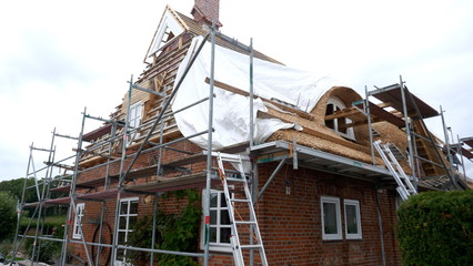 A new thatched roof for an old residential building.  Germany Schleswig Holstein. © anela47