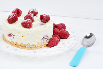 Mini cheesecake with white chocolate and raspberries on a plate