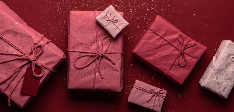 Row of gift boxes in craft papers with threads