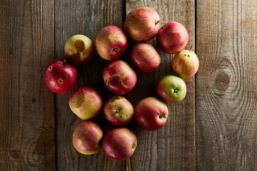 top view of ripe juicy apples on brown wooden surface