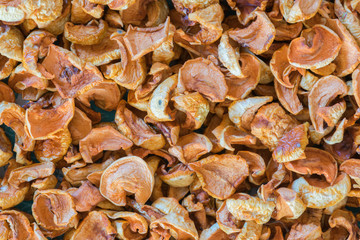 Dried fruits apples and pears scattered on the canvas as a background