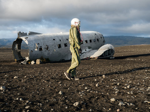 Anonymous pilot walking near crashed aircraft