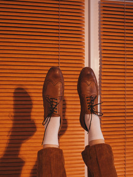 Crop woman in brogues and brown pants