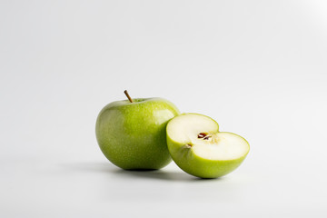 Fresh cut green apple over a white background