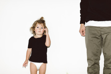 little girl standing next to her dad
