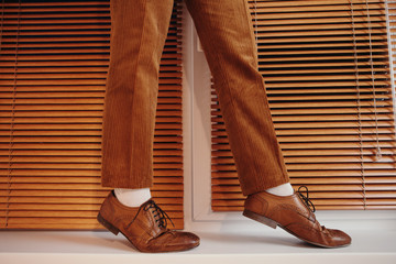 Crop woman in brogues and brown pants