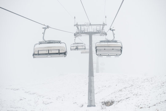 Riding chairlifts in mist and snow
