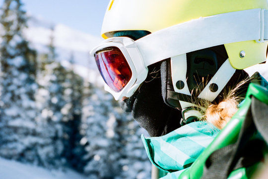 Close up of a teenage skier in helmet and goggles