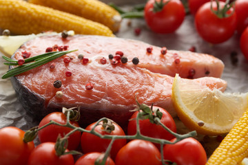 raw fresh salmon with spices, lemon and tomatoes