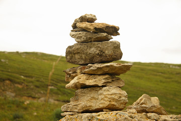 Balanced stones on the alpine meadow near caucasus mountains
