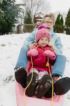 Grandmother Riding Sled with Child