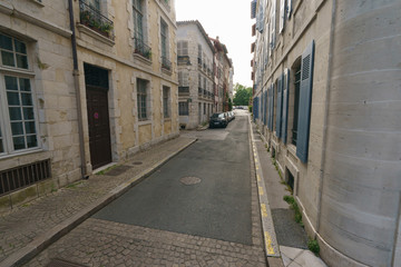 Narrow streets of medieval city Bayonne in summer day. Troubles of tourism.