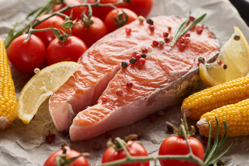 raw fresh salmon with spices, lemon, corn and tomatoes