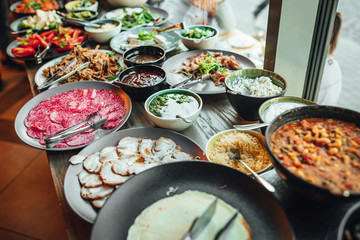 Brunch table in coffee shop, delicious food, Breakfast or brunch table filled with all sorts of delicious food