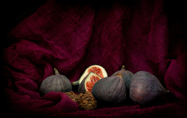 Fresh figs with chocolate truffles on the purple background