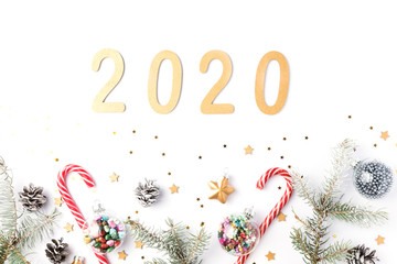 Christmas frame made of fir branches, cones, gold stars and decorations. Christmas wallpaper. 2020 background isolated on white. Flat lay, top view, copy space