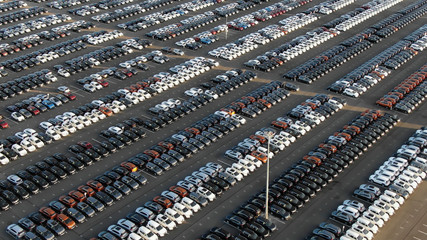 storage parking area with cars sorted by color in summer