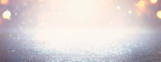 background of abstract glitter lights. silver, light blue and gold. de-focused. banner
