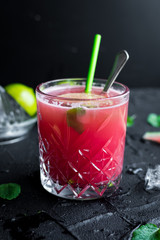 Watermelon drink in glasses with lime and mint