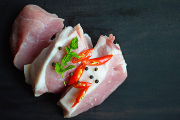 Fresh raw meat on a black background.