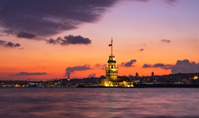 Fototapeta na wymiar turkish tower in sea on sunset evening, violet sky summer