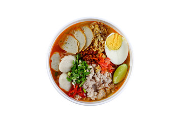 Spicy tom yam pork noodle soup with lemongrass, chili paste, boiled egg and lime juice isolated on white background
