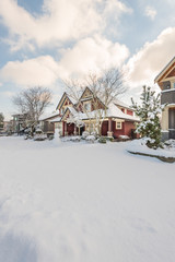 A perfect neighbourhood. Houses in suburb at Winter in the north America. Luxury houses covered nice snow.