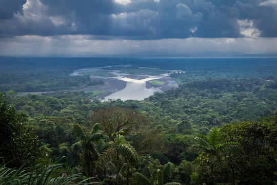 Amazonian viewpoint called Indichuris, lanscape located in Ecuador. The confluence of the Pastaza and Puyo rivers, a dense vegetation and a sky covered with large clouds can be appreciated.