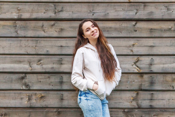 Happy girl smiling. Beauty portrait young happy positive laughing brunette woman on wooden wall...