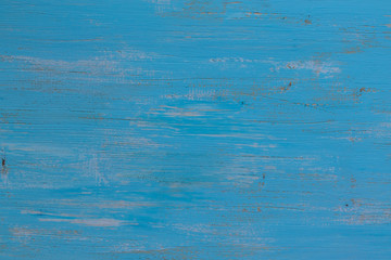 Background in the form of a wooden surface painted in blue with light spots with a horizontal texture