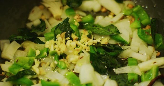 Slow motion shot of cooking a simple and easy vegetarian curry.
