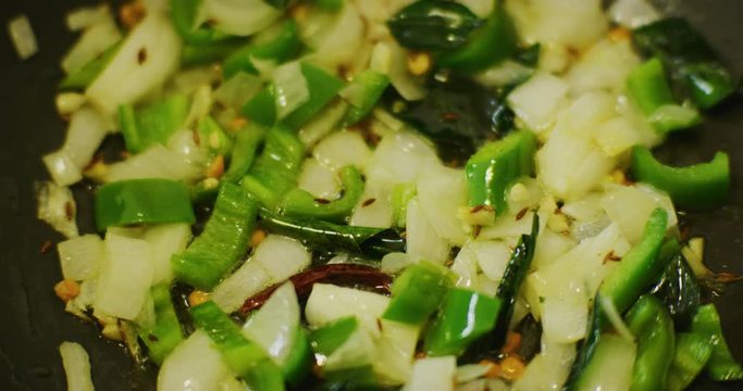 Slow motion shot of cooking a simple and easy vegetarian curry.