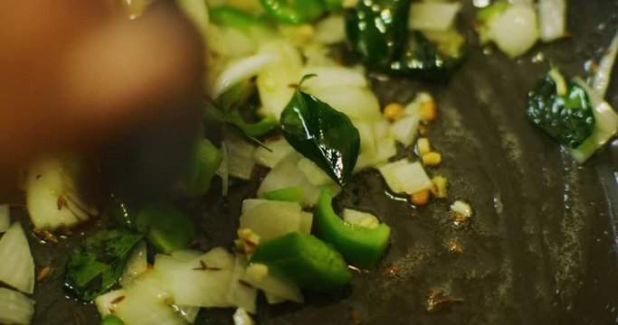 Slow motion shot of cooking a simple and easy vegetarian curry.