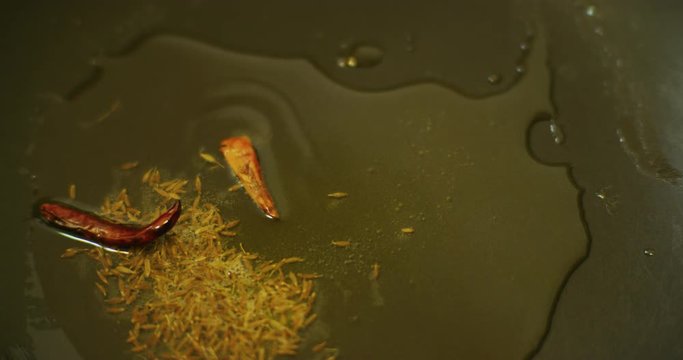 Slow motion shot of cooking a simple and easy vegetarian curry.