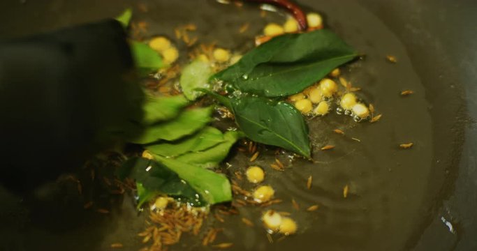 Slow motion shot of cooking a simple and easy vegetarian curry.