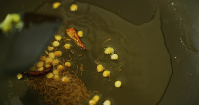 Slow motion shot of cooking a simple and easy vegetarian curry.