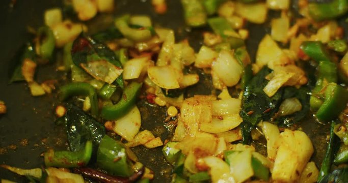 Slow motion shot of cooking a simple and easy vegetarian curry.