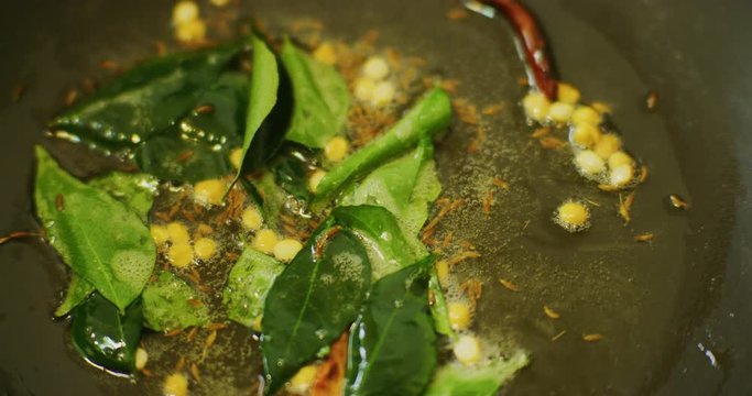 Slow motion shot of cooking a simple and easy vegetarian curry.