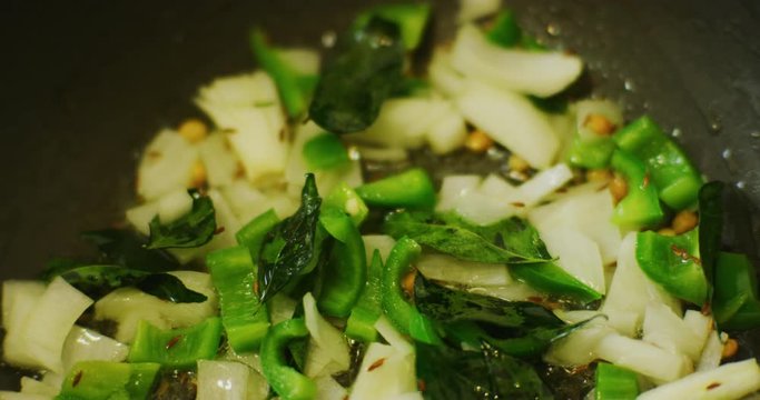 Slow motion shot of cooking a simple and easy vegetarian curry.