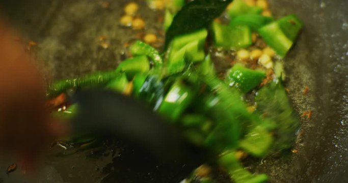 Slow motion shot of cooking a simple and easy vegetarian curry.