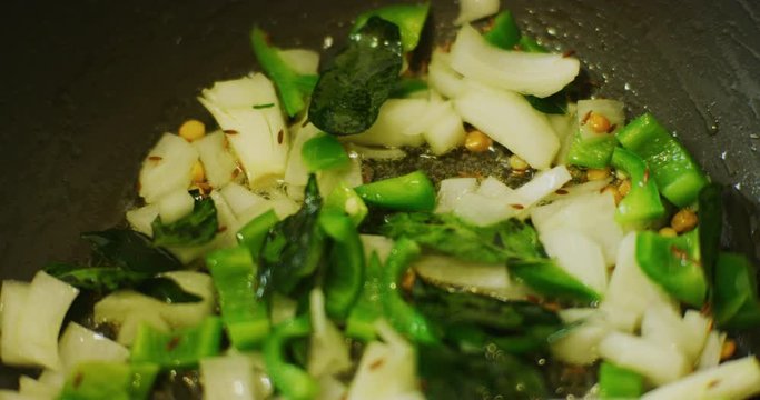 Slow motion shot of cooking a simple and easy vegetarian curry.
