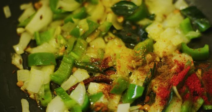 Slow motion shot of cooking a simple and easy vegetarian curry.