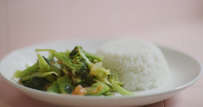 Slow motion shot of cooking and plating a simple and easy vegetarian curry.