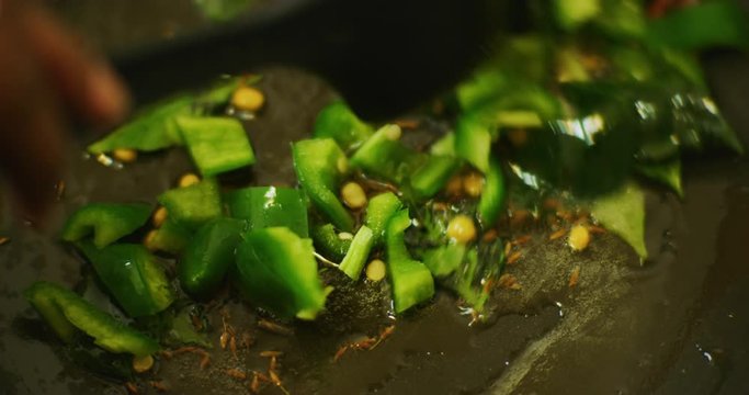 Slow motion shot of cooking a simple and easy vegetarian curry.