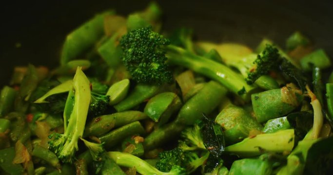 Slow motion shot of cooking a simple and easy vegetarian curry.